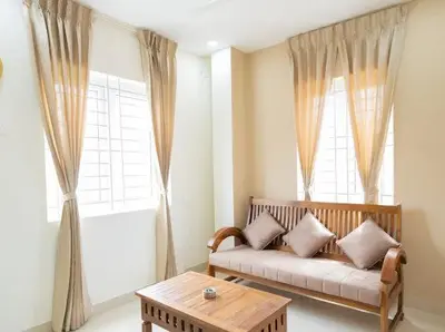 a living room with a couch and a table at Sree Home Stay and Service Apartment in Coimbatore