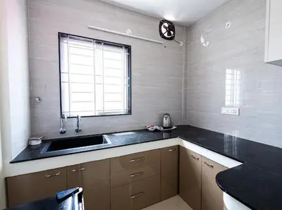 a kitchen with a sink and a window at Sree Home Stay and Service Apartment in Coimbatore