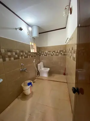 a bathroom with a toilet and a bucket in it at Coorg jungle Cottage in Kushālnagar