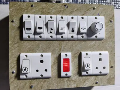 a close up of a remote control on a table at Hotel Nirmal Cottage Gobichettipalayam in Siruvalūr