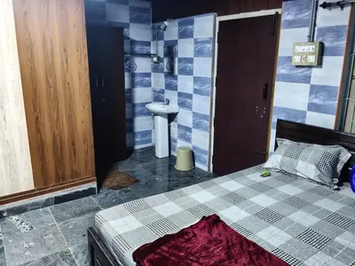 a bedroom with a bed and a sink and a toilet at Hotel Nirmal Cottage Gobichettipalayam in Siruvalūr