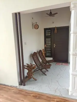 two chairs sitting in the corner of a room at Nihave in Attappādi