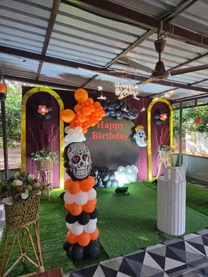 a display with a skull and a happy birthday sign at Mango Bite Farmstay in Pollāchi