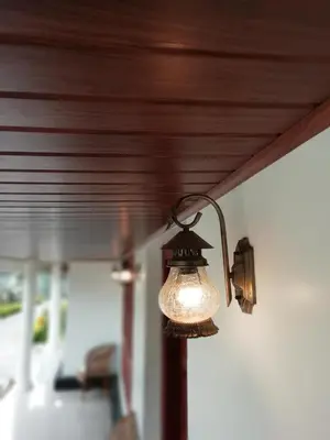 a light hanging from the ceiling of a room at Salisbury Manor Heritage Inn in Marayoor