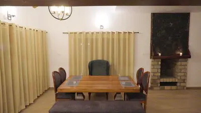 a conference room with a wooden table and chairs at 3 Bhk Villa Ooty - Casa de Amor by EBR in Ooty