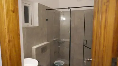 a bathroom with a shower with a toilet and a sink at 3 Bhk Villa Ooty - Casa de Amor by EBR in Ooty
