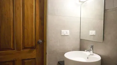 a bathroom with a sink and a mirror at 3 Bhk Villa Ooty - Casa de Amor by EBR in Ooty