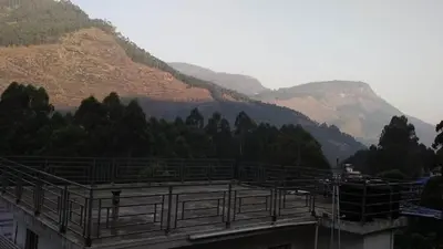 a building with a view of a mountain at Shobha home stay in Vattavada