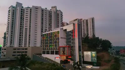 a group of tall buildings in a city at Nestlay Suites by TC One in Kozhikode