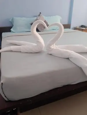 a bed with two snakes forming a heart on it at Siddhartha Residency in Mysore