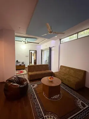 a living room with a couch and a coffee table at Siddhartha Residency in Mysore