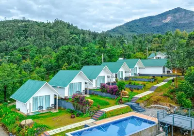 an aerial view of a house with a pool at Gardenia Pool Resort Kanthalloor by VOYE HOMES Mountain View Stay Near Bhramaram view Point in Kanthalloor