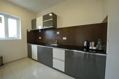 a kitchen with a sink and a counter top at Mirage Luxuria Inn in Vythiri