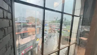 a view of a city from a window at Hotel Riviera in Mananthavady