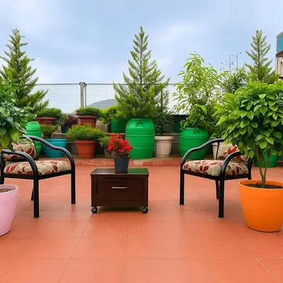 a patio with two chairs and a table with potted plants at Dreamview Cottage by BEN Groups in Ooty