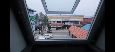a view from a window of a street with a car at AZURE stay happy in Pudunagaram