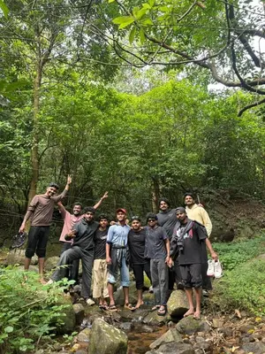 a group of people standing on a trail in the woods at Hima Pool Villa in Padinjarathara
