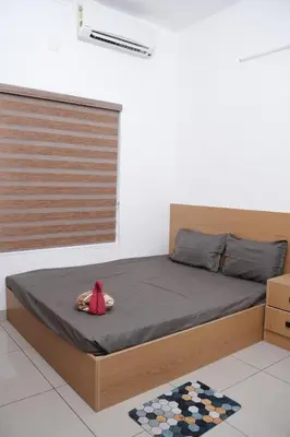 a bed with a red stuffed animal sitting on it at Serene Cottage - Home away from Home in Vythiri