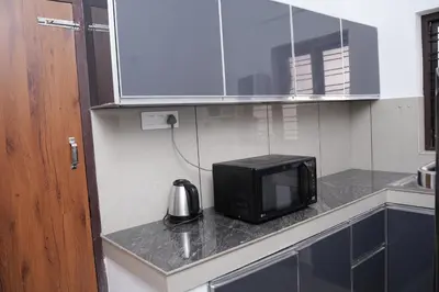 a microwave sitting on a counter in a kitchen at Serene Cottage - Home away from Home in Vythiri
