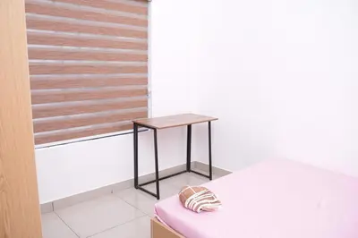 a small table sitting on top of a bed in a room at Serene Cottage - Home away from Home in Vythiri