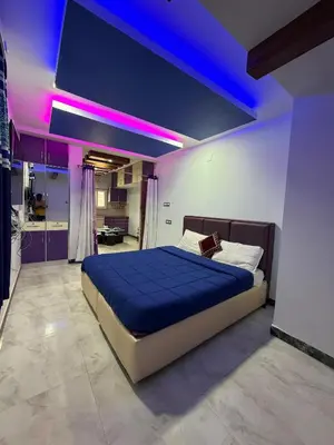 a bedroom with a large bed with purple lighting at Forever Cottage by sait's hospitality in Ooty