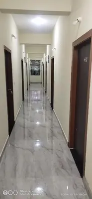 a hallway of a building with a marble floor at SOWMYA RESIDENCy in Piriyāpatna