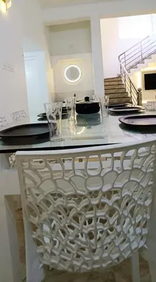 a table with glasses and plates on top of it at Heaven Cloud Stay Hub Attappadi in Attappādi