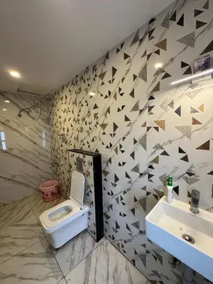 a bathroom with a toilet and a sink at Black Dot Stays - Mehand Veera Residency in Kodaikānāl