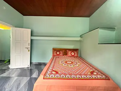 a small room with a bed in a room at Leaf links Coorg in Siddapur