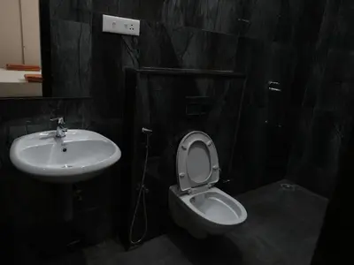 a bathroom with a toilet and a sink at Amaira Studio living - Coimbatore in Coimbatore