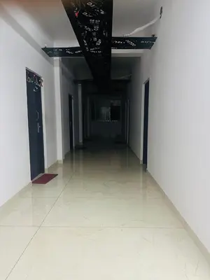 an empty hallway with white walls and a ceiling at AZURE stay happy in Pudunagaram