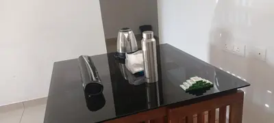 a black counter top with a sink in a room at Green palace service villa in Kalpetta