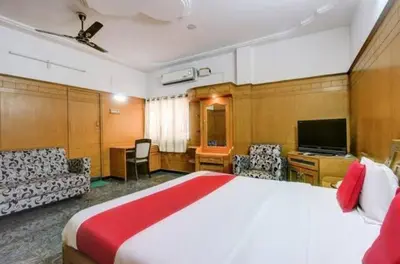 a hotel room with a large bed and a television at The vivekam Homestay nr Hindustan college Nava india in Singānallūr