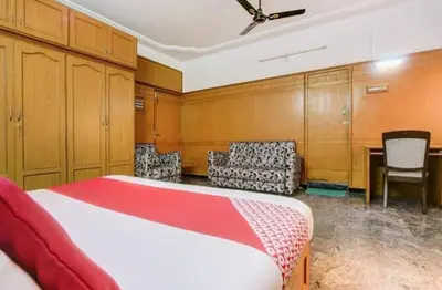 a bedroom with a bed and a table and chairs at The vivekam Homestay nr Hindustan college Nava india in Singānallūr