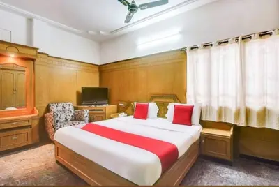 a bedroom with a large bed and a television at The vivekam Homestay nr Hindustan college Nava india in Singānallūr