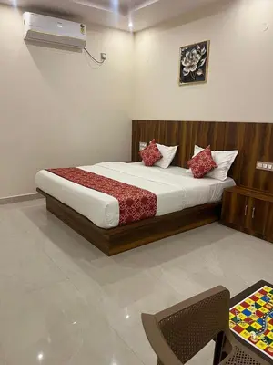 a bedroom with a large bed in a room at Estoria Hotel and Resort in Kadakola