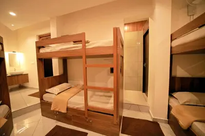 a room with two bunk beds in it at LUMARISE Premium Wayanad Business Hotel in Sultan Bathery