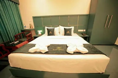a hotel room with a bed with bows on it at LUMARISE Premium Wayanad Business Hotel in Sultan Bathery