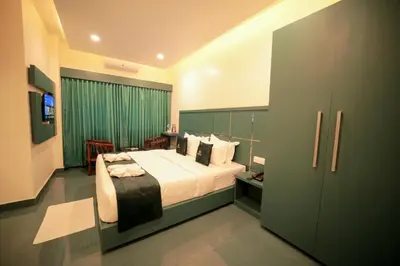 a bedroom with a large bed in a room at LUMARISE Premium Wayanad Business Hotel in Sultan Bathery