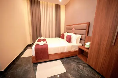 a hotel room with a bed and a window at LUMARISE Premium Wayanad Business Hotel in Sultan Bathery