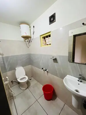 a bathroom with a toilet and a sink at Chillwind Service villa in Padinjarathara