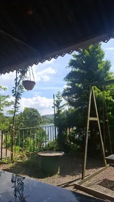 a view of a patio with a tree and a swing at Chillwind Service villa in Padinjarathara