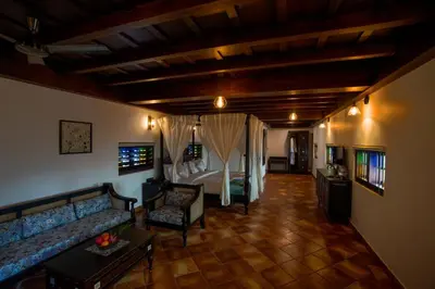 a living room with a couch and a bed at SVS Arena in Kodali