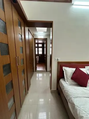a bedroom with a bed and a hallway at Villa Vinaya- Comfort, Calm & Charm in Mysore in Mysore
