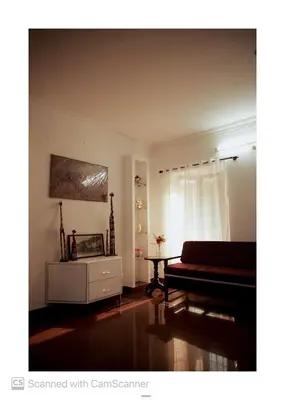 a living room with a piano and a table at Coorg River Song Homestay in Kushālnagar