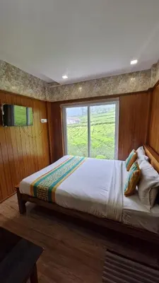 a large bed in a room with a window at Meadows mist ooty in Ooty
