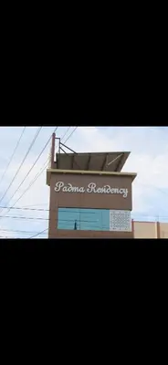a picture of a pharmacy sign on a building at Padma residency in Coimbatore