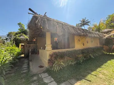 a small house with a straw roof at Earthen Pool Villa! Redefining Luxury! in Marayoor