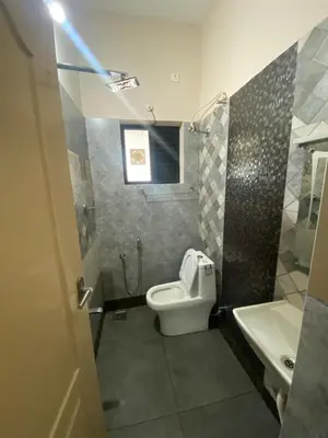 a bathroom with a toilet and a sink at Neurogreen Apartments in Kottakkal