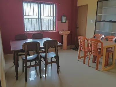 a dining room with a table and chairs at Coorg villas & homes in Madikeri